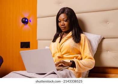 Young African Introvert Woman Using Her Laptop In Bed