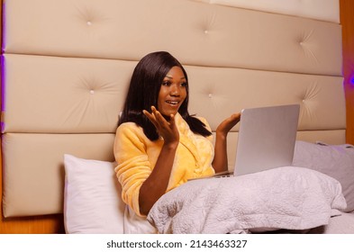 Young African Introvert Woman Using Her Laptop In Bed