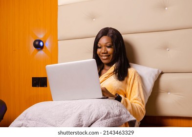 Young African Introvert Woman Using Her Laptop In Bed