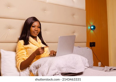 Young African Introvert Woman Using Her Laptop In Bed