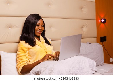 Young African Introvert Woman Using Her Laptop In Bed