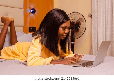 Young African Introvert Woman Using Her Laptop In Bed