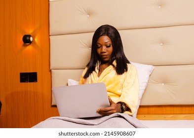 Young African Introvert Woman Using Her Laptop In Bed