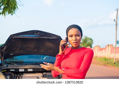 Young African Lady Making A Phone Call After Her Car Fails