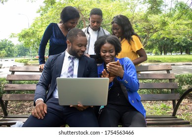 young african male and female students doing a research on the internet with their laptop - Shutterstock ID 1754563466