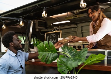 Young African Man Buying Meal From Food Truck - Modern Business And Take Away Concept