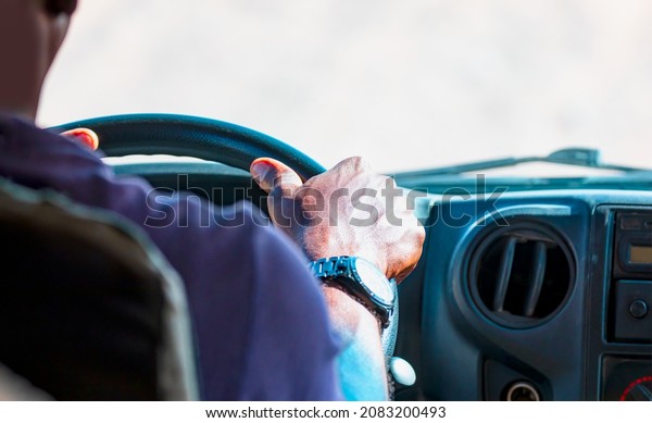 Young an African man\
is driving carefully