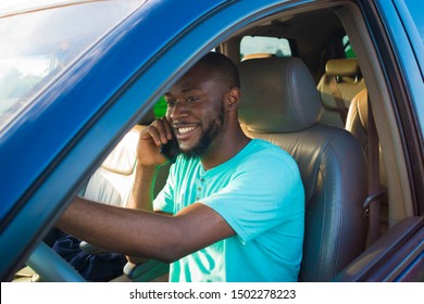 young African man driving his car and making a phone call - Shutterstock ID 1502278223