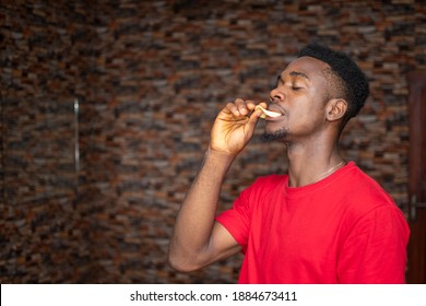 Young African Man Eating Chips