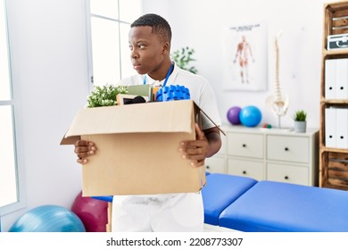 Young African Man Fired Holding Box With Personal Items At Physiotherapy Clinic