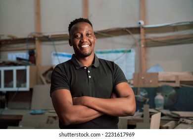 Young African man folding arms in factory - Powered by Shutterstock