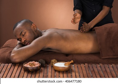 Young African Man Getting Massage In Spa