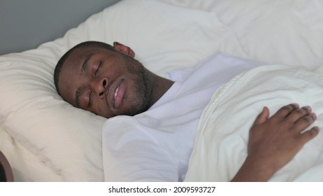 Young African Man Going To Bed And Sleeping 