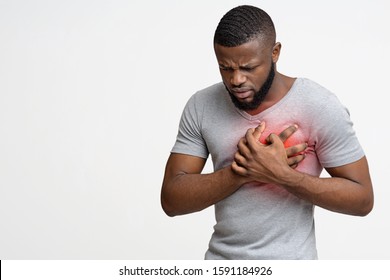 Young African Man Having Heart Ache, Holding Hand On Chest. Heart Attack Or Stroke, Copy Space