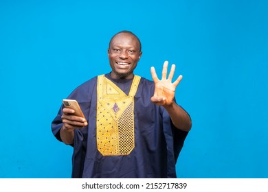 Young African Man Holding Up Four Fingers At The Camera.