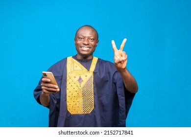 Young African Man Holding Up Two Fingers At The Camera.