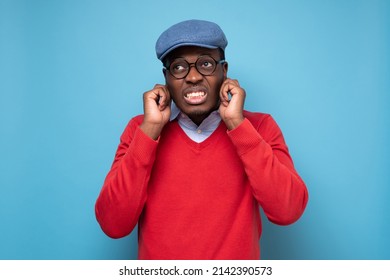 Young African Man Plugging Ears With Fingers