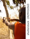 A young African man using a traditional catapult 