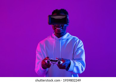 Young African Man Wearing VR Glass Headset Playing Game With Joystick Controller In Futuristic Purple Cyberpunk Neon Light Background