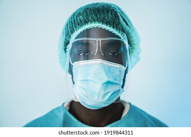 Young African Medical Doctor Working Inside Hospital During Coronavirus Outbreak - Focus On Mask