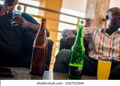 Young African Men Sitting At A Local Bar Drinking Beer