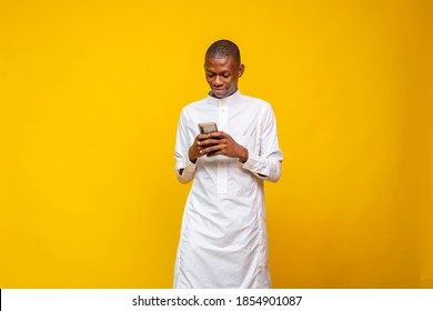 Young African Muslim Man Using His Phone