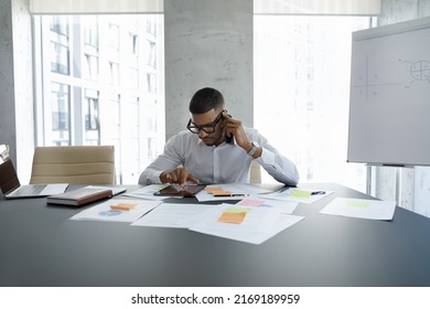 Young African Office Employee, Business Owner Or Company Executive Manager Sit At Desk In Boardroom Make Call Discuss On-line Project Use Digital Tablet. Workflow, Lifestyle, Modern Tech Usage Concept