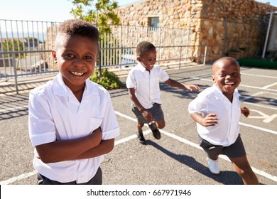 Young African Schoolboys Running In School Playground