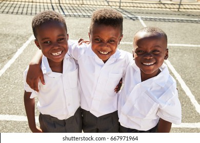 Young African Schoolboys Smiling To Camera In A Playground