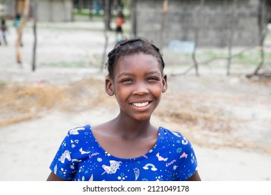 Young African Village Girl In Front Of Her House 