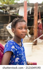 Young African Village Girl In Front Of Her House 