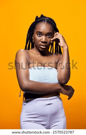 Similar – Image, Stock Photo Thoughtful young bold African American female model in trendy outfit and sunglasses looking away on pink background
