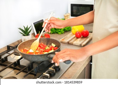 Young African Woman Cooking In Kitchen. Cooking At Home. Healthy Food. Dieting Concept.