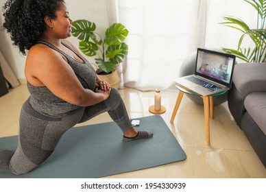 Young African Woman Doing Pilates Virtual Fitness Class With Laptop At Home - Sport Wellness People Lifestyle Concept