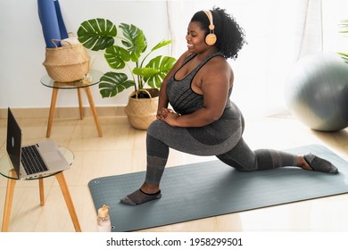 Young African Woman Doing Pilates Virtual Fitness Class With Laptop At Home - Sport Wellness People Lifestyle Concept