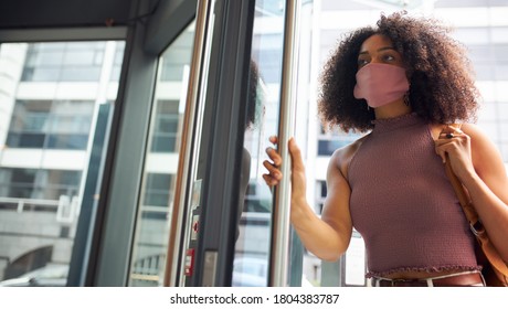 Young African Woman Entering Office Wearing Face Mask Looking Off Camera