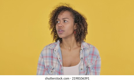 Young African Woman Feeling Scared, Frightened On Yellow Background