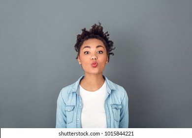 Young African Woman Isolated On Grey Wall Studio Casual Daily Lifestyle Kissing Camera