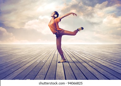 Young African Woman Listening To Music And Dancing