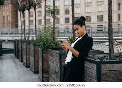 Young African Woman Recording Voice Message On Phone And S Smiling