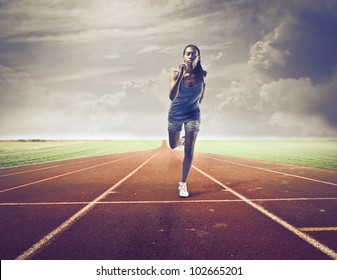 Young African Woman Running On A Running Track