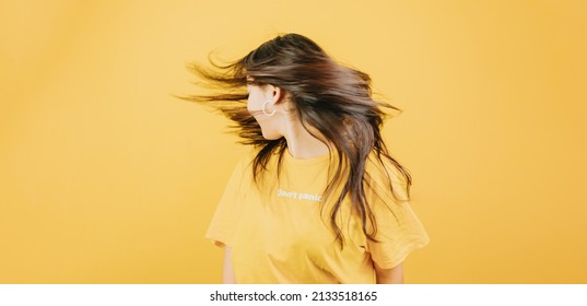 Young african woman waving hair   dancing happy   cool attitude concept posing isolated over yellow color wall background  Daily expressions and copy space in studio 