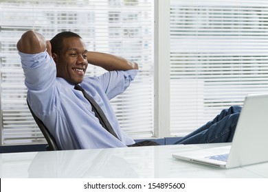 Young African-American Business Man Taking A Break At His Desk, Horizontal 