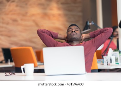 Young African-American business man taking a break at his desk