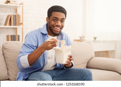 Young African-american Man Eating Noodles, Chinese Food Delivery Service Concept, Copy Space