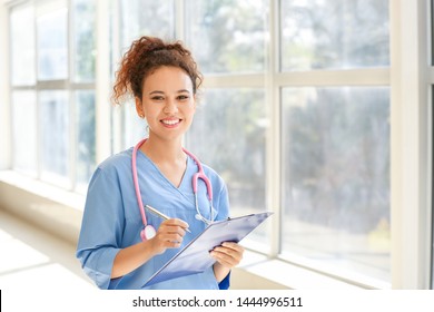 Young African-American nurse in clinic - Shutterstock ID 1444996511