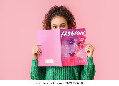 Young African-American woman in green sweater reading magazine on pink background - Shutterstock ID 2142750739