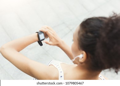 Young African-american Woman Using Smart Watch, Girl Preparing For Jogging, Copy Space, Over Shoulder Shot