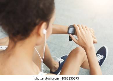 Young African-american Woman Using Smart Watch, Girl Preparing For Jogging, Copy Space, Over Shoulder Shot