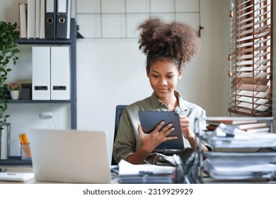 Young afro african american millennial employee trainee working on office desk. - Shutterstock ID 2319929929